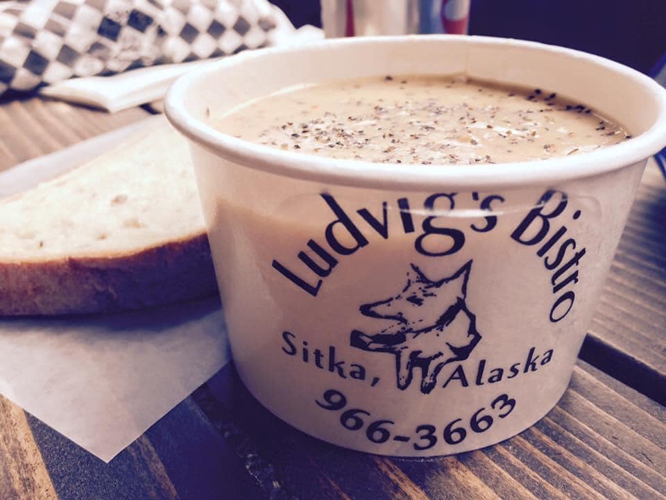Freshly baked bread, and chowder in a cup that says Ludvig’s Bistro