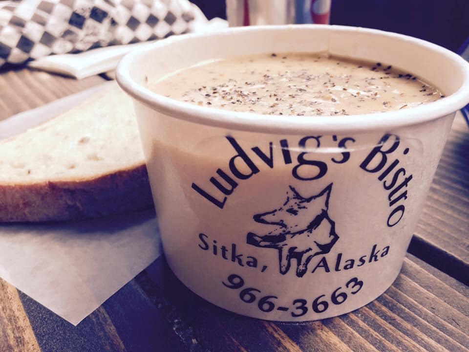 Freshly baked bread, and chowder in a cup that says Ludvig’s Bistro