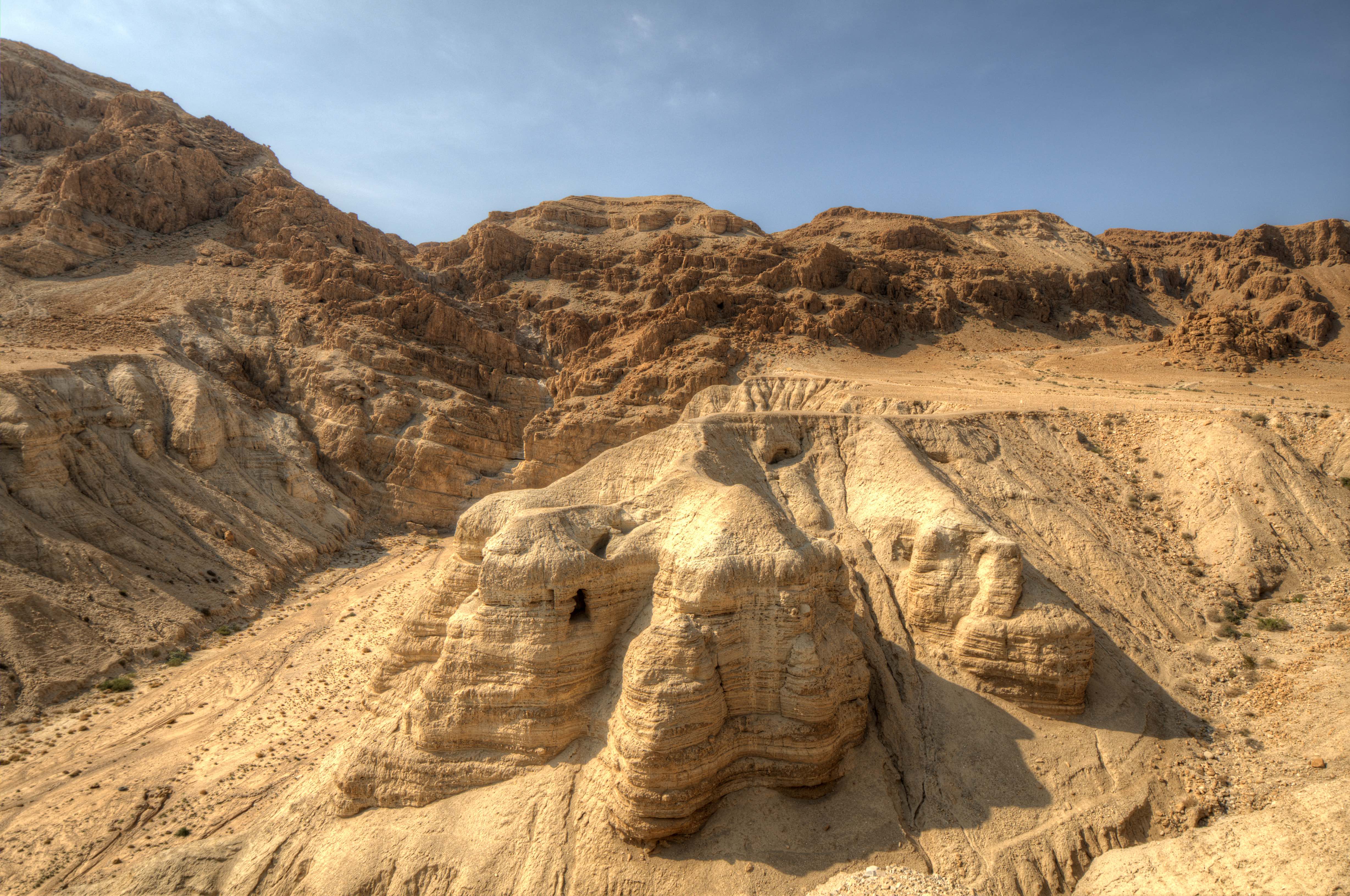 Wide shot of the sandy desert caves where the Dead Sea Scrolls were discovered