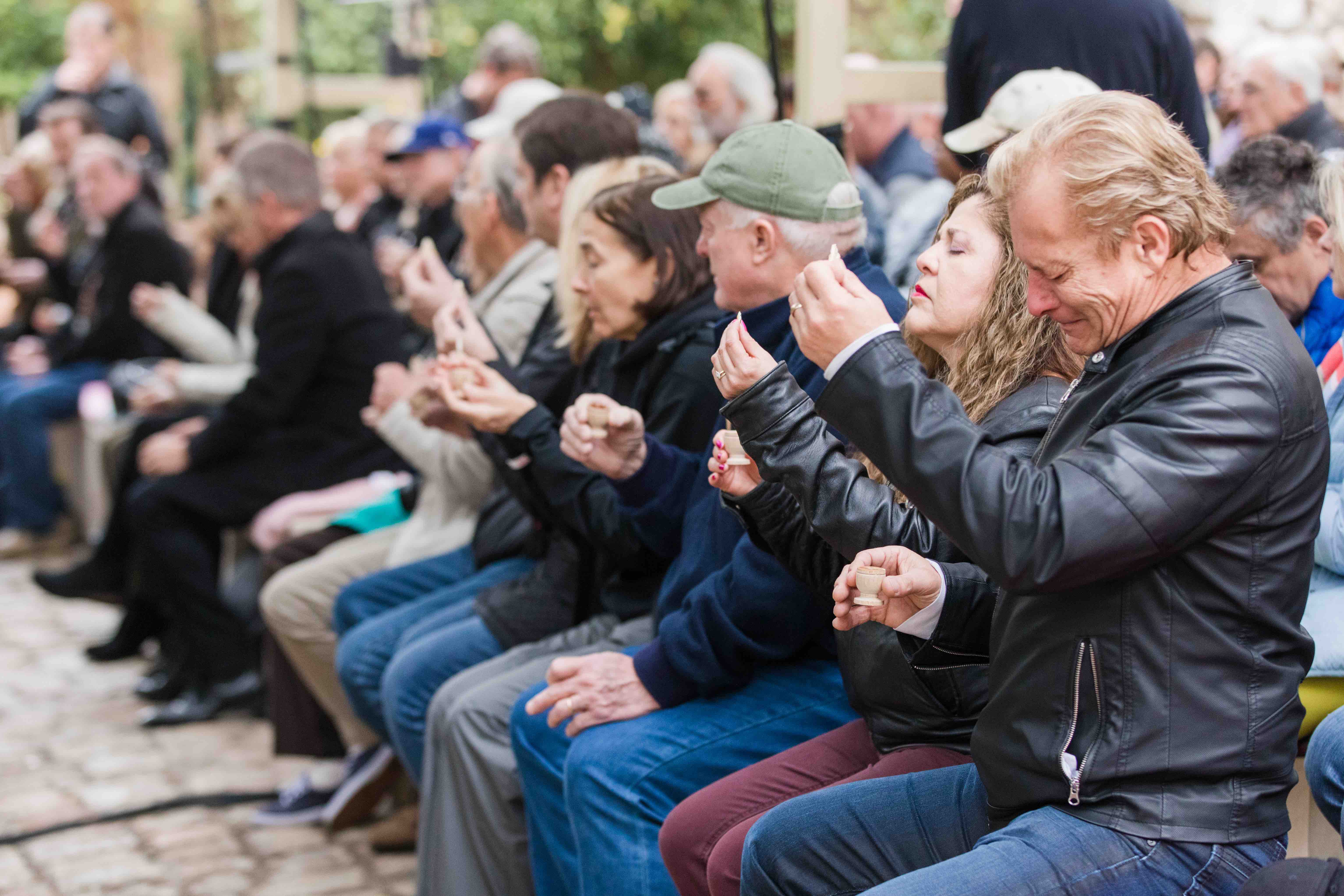 Small group praying before taking communion in the Garden Tomb.