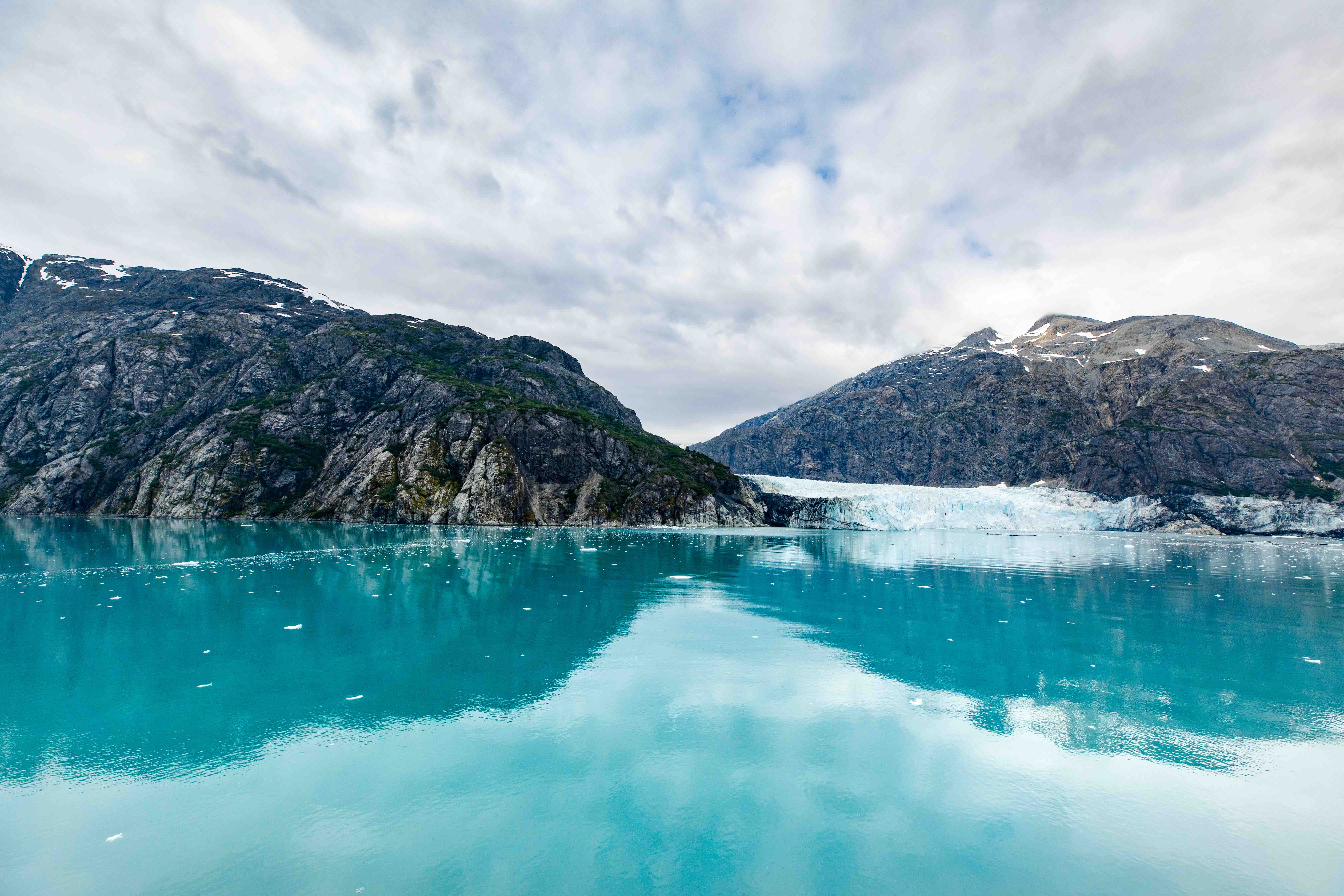 Mountains and aqua blue water surrounding Mendenhall Glacier