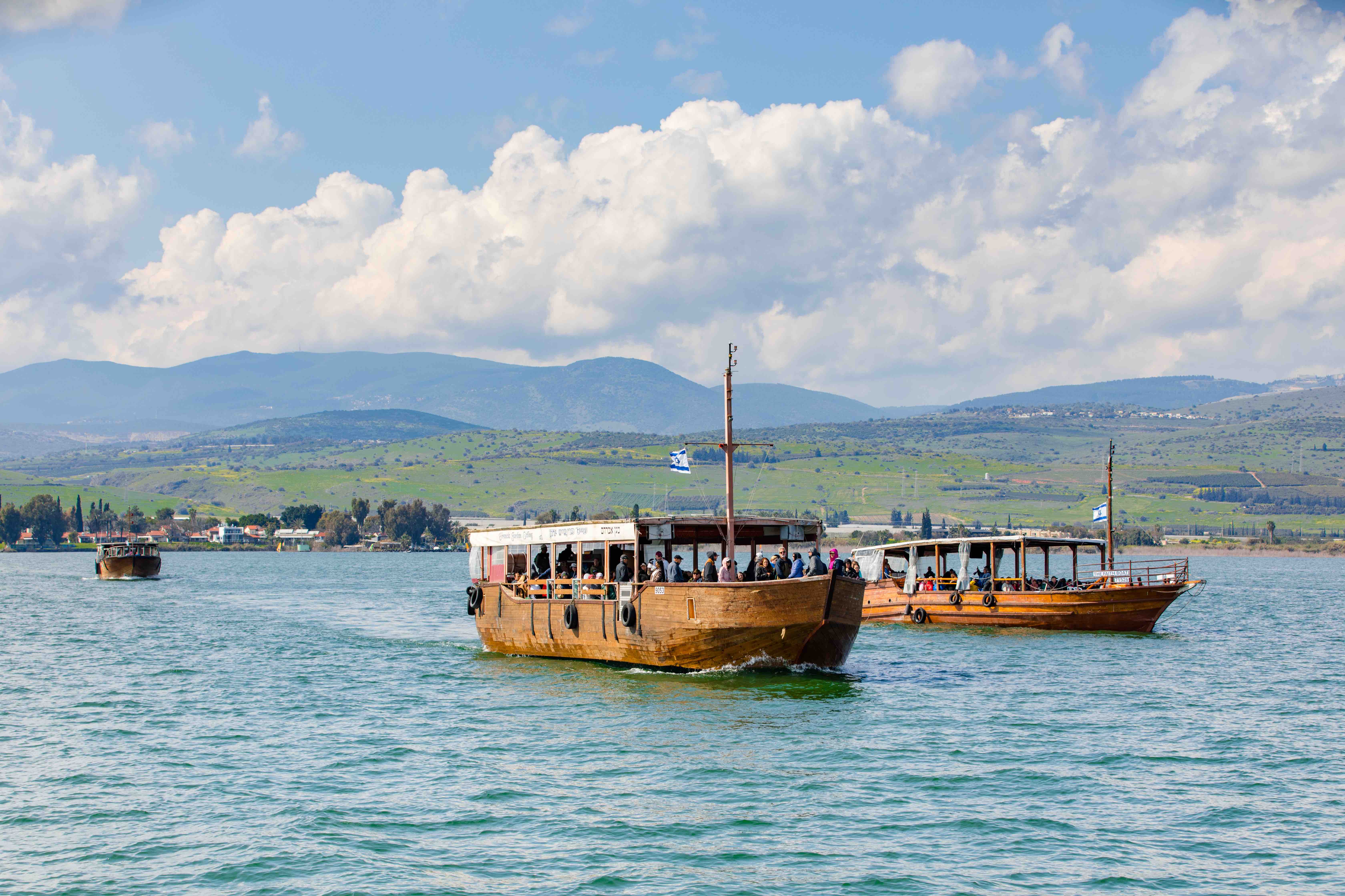 Boats on the clear blue waters of the Sea of Galilee