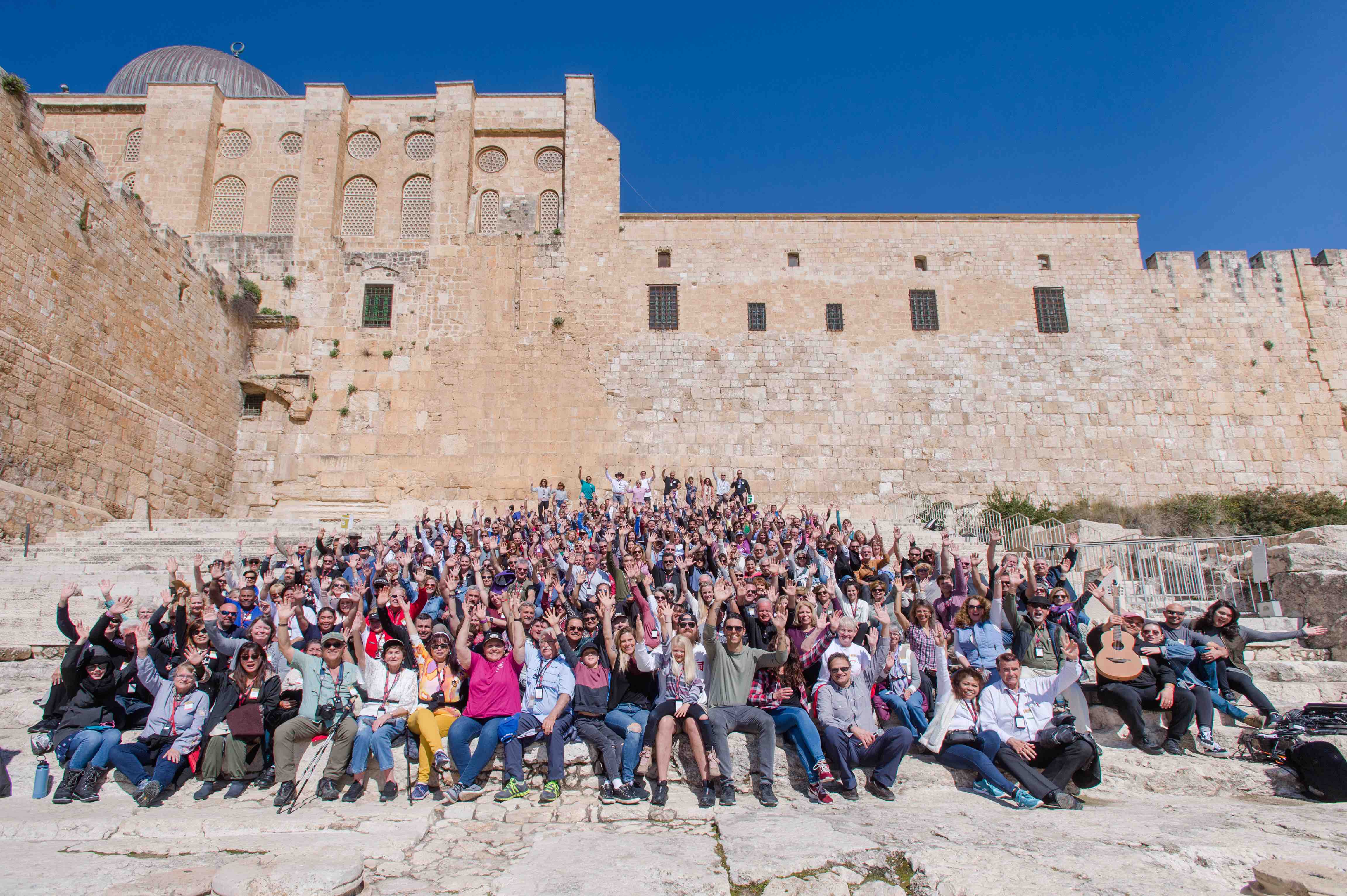 Large group waving from the Southern Steps of the Temple in Jerusalem.