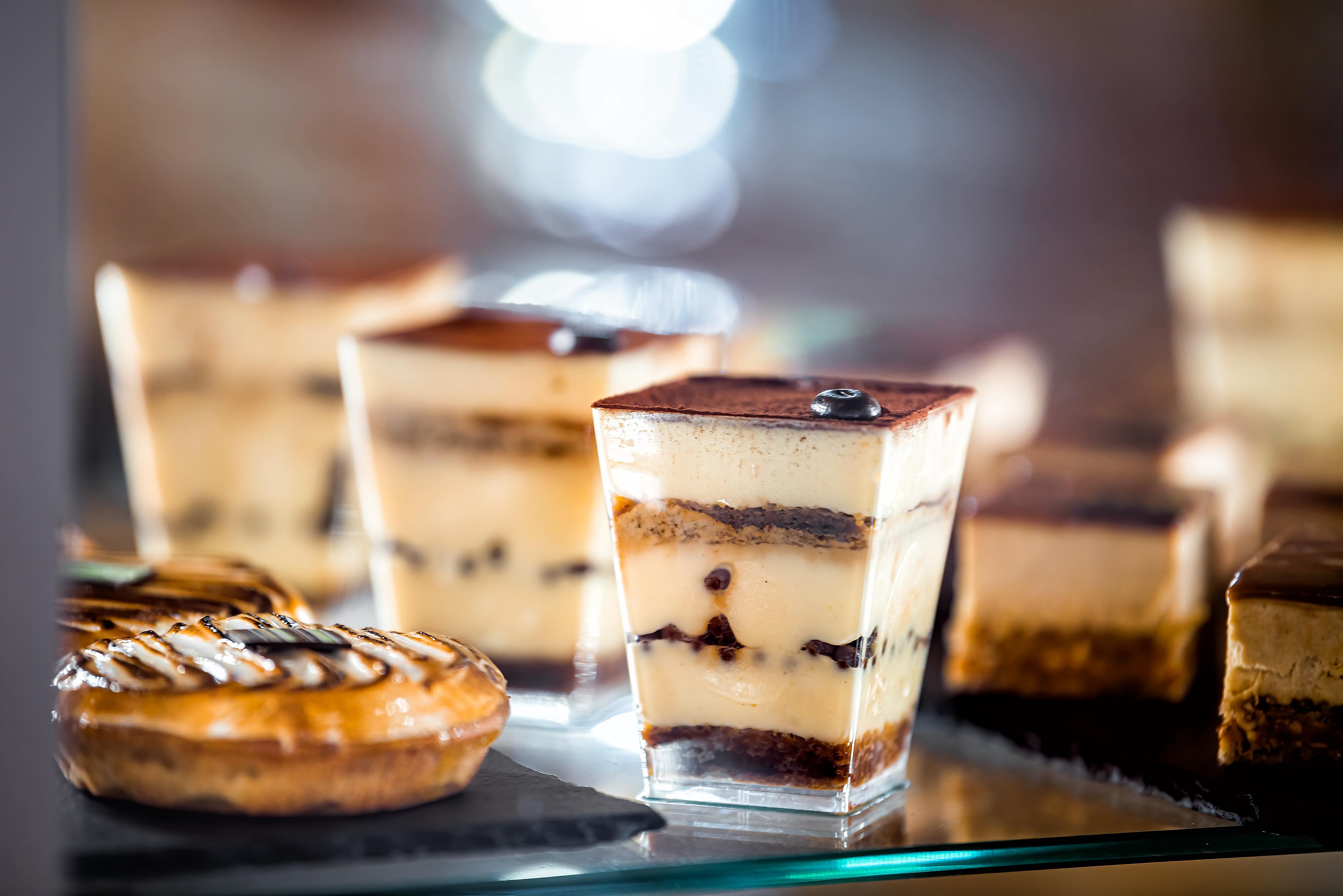 Closeup of chocolate dessert tiramisu pastries on tray display in bakery shop store