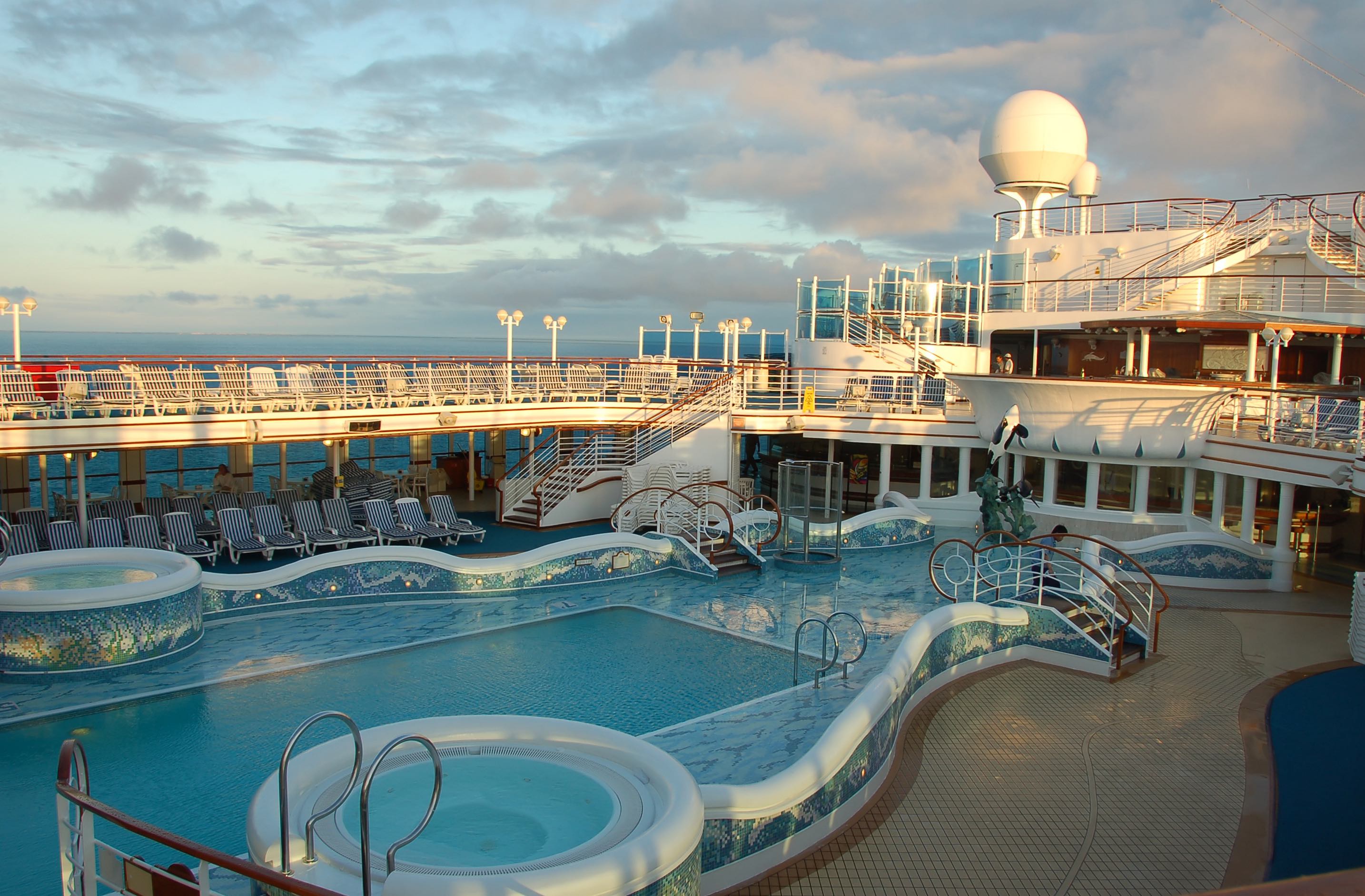 View pools and spa facilities on top deck of a cruise ship.
