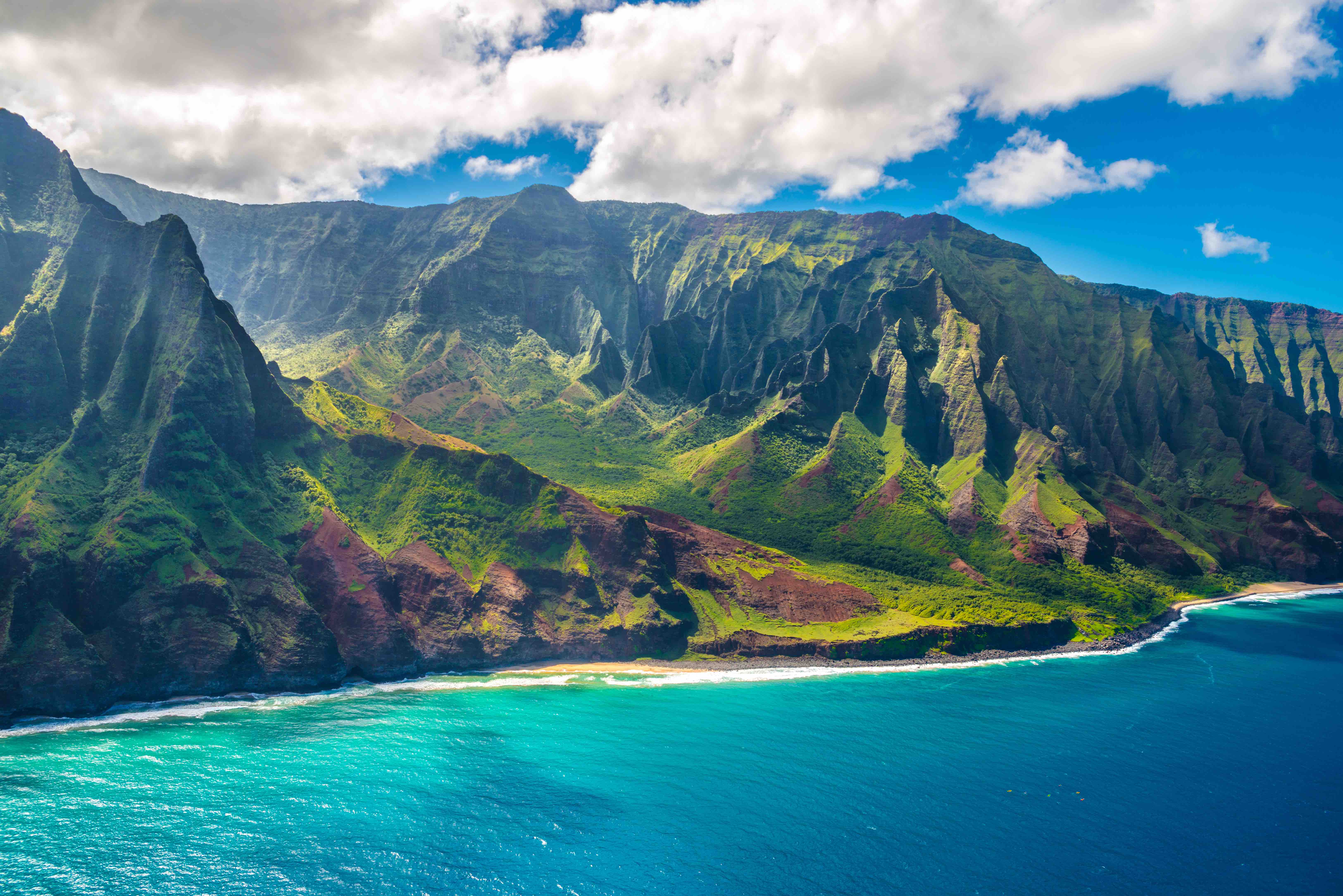 Green mountain cliffs and clear blue water of Napali Coast on Kauai island, Hawaii