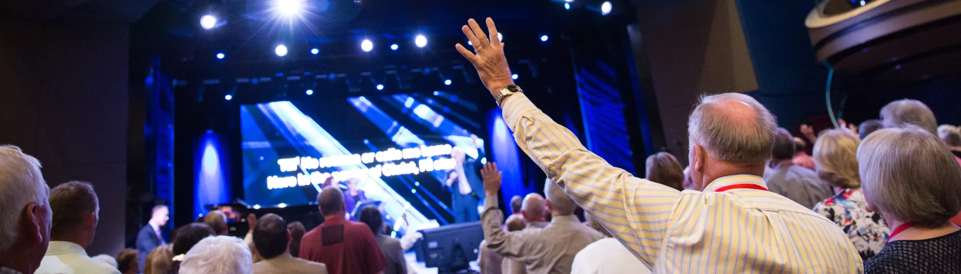 Man lifting his hand during a concert