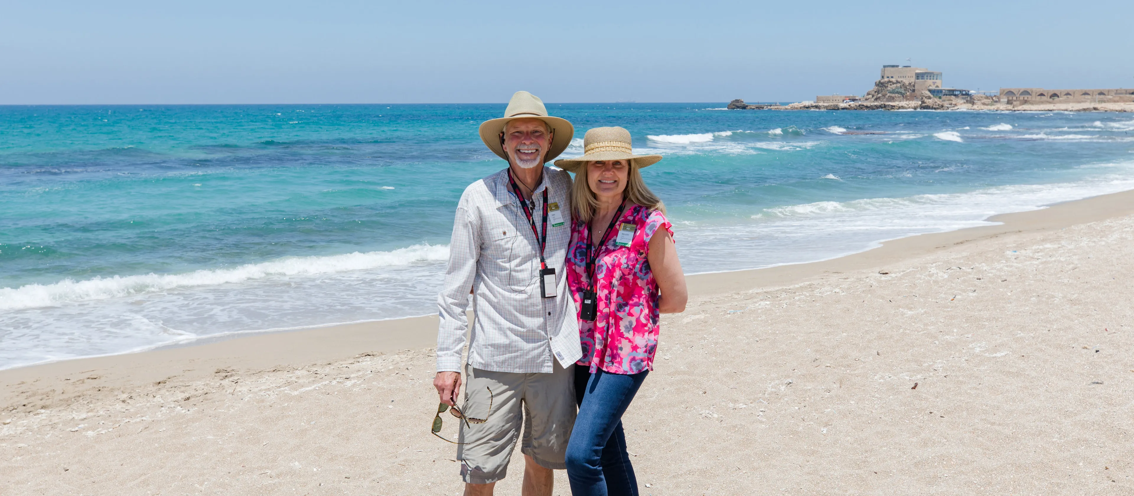 A couple standing together on the beach in Israel