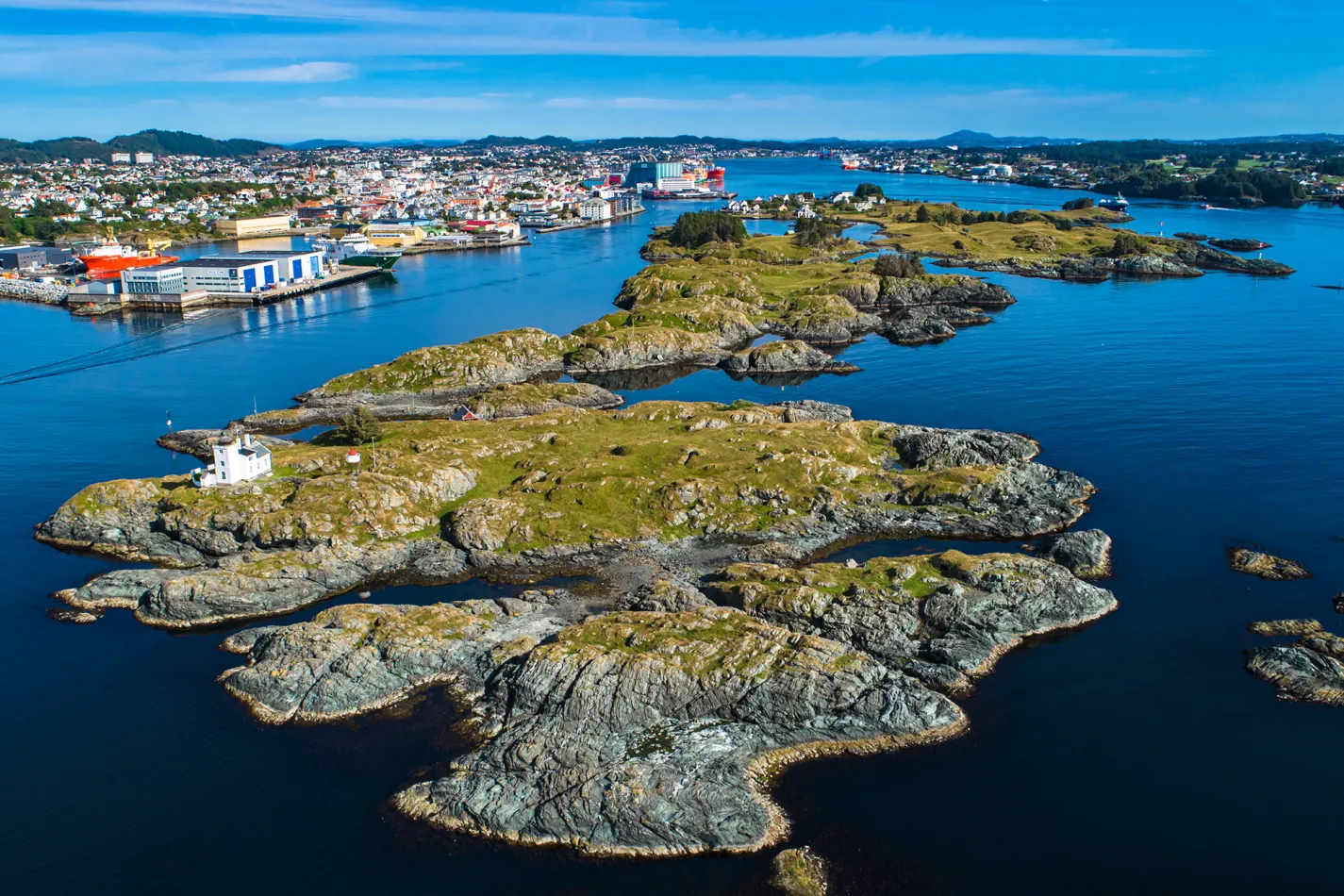 Small rocky islands near a city on the mainland