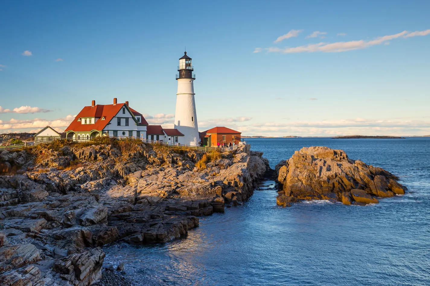 Lighthouse on a rocky cliff at the water's edge