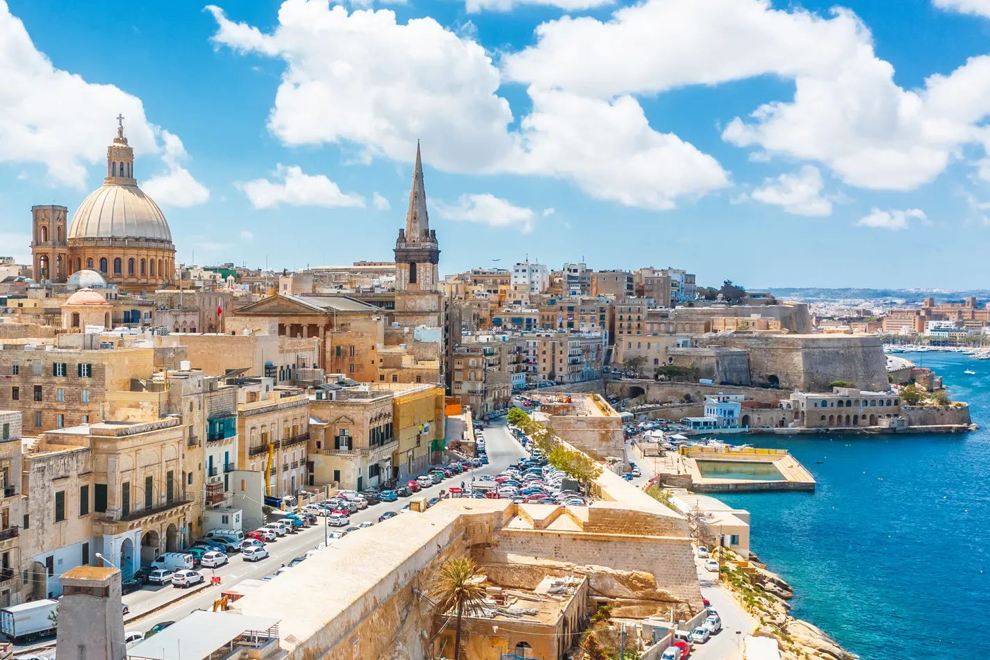 Valletta, Malta skyline with historic stone buildings, church domes, and the Grand Harbour