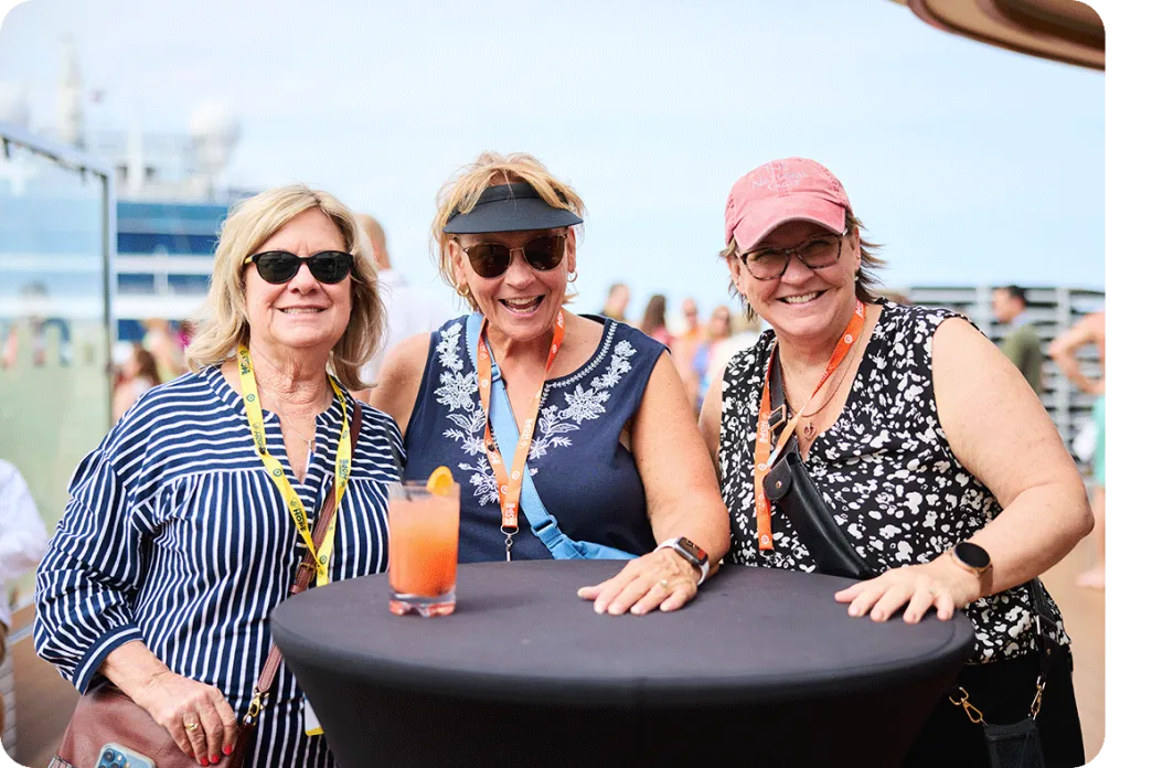 Three smiling women on a cruise ship