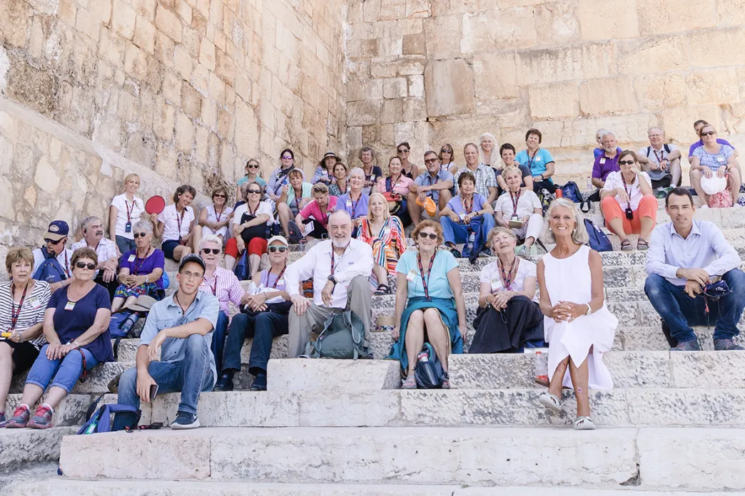 Anne Graham Lotz sitting with travelers on the Southern Steps in Israel