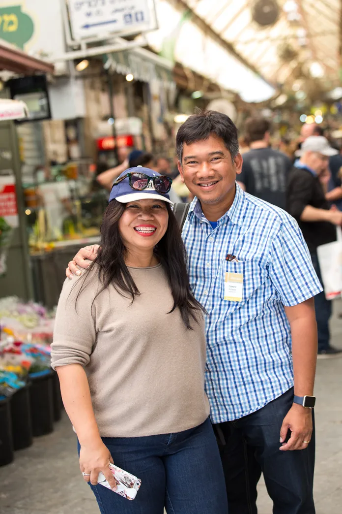 A smiling couple standing together in the Jerusalem market