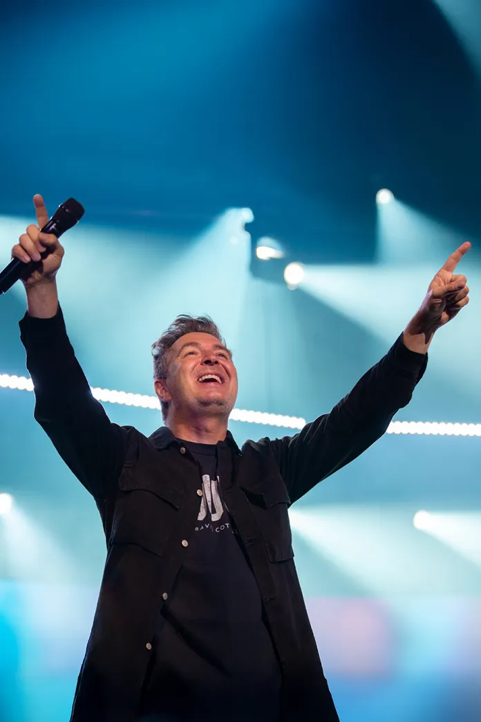 Travis Cottrell  raising his arms in worship