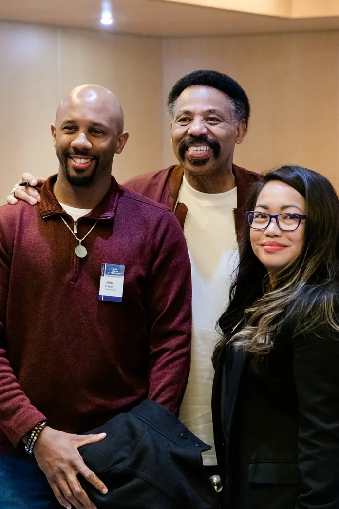 Tony Evans taking a picture with people