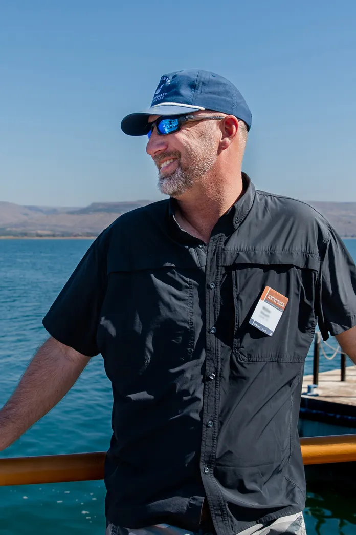 Smiling man with the Sea of Galilee in the background