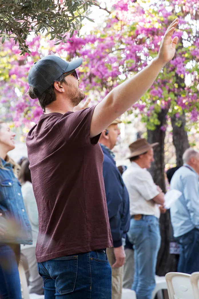 Man standing with arms raised