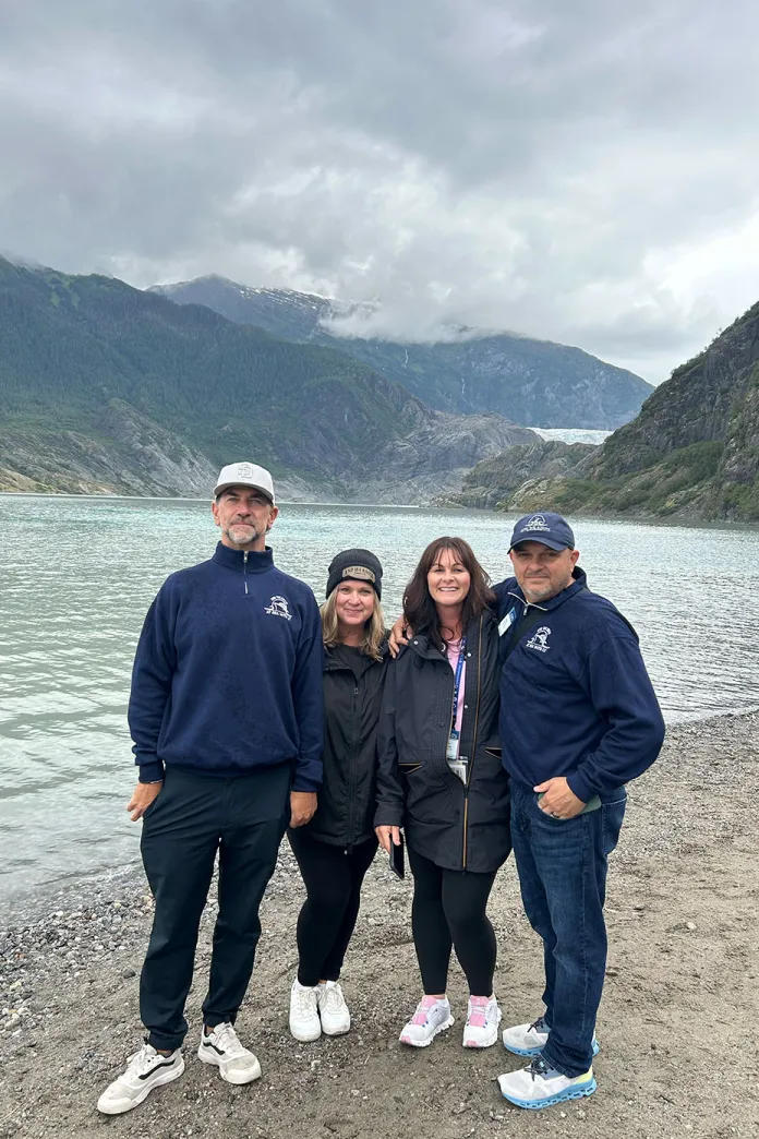 Group of travelers with scenic Alaskan landscape in the background