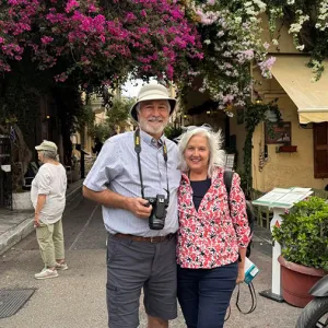 Smiling couple standing together in a city in the Mediterranean