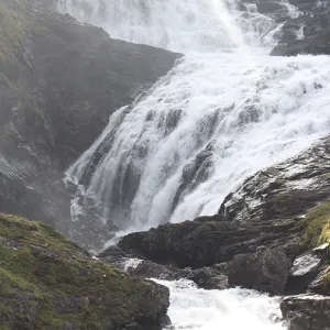 A large waterfall rushing down into a river