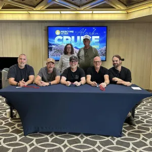 Travelers taking a photo with MercyMe band